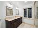 Bathroom featuring dual sinks, granite countertops, a window, and an enclosed shower at 536 N Williams St, Denver, CO 80218