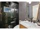 Stylish bathroom featuring a unique black and white patterned wall and glass enclosed shower at 536 N Williams St, Denver, CO 80218