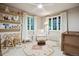Charming Bedroom with bright windows, built-in shelving, a rocking chair, and a cozy crib at 536 N Williams St, Denver, CO 80218