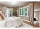 Cozy bedroom showcasing hardwood floors, neutral walls, a large window, and a walk-out balcony at 536 N Williams St, Denver, CO 80218