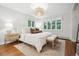 Bright bedroom with hardwood floors, modern chandelier, and large windows offering natural light at 536 N Williams St, Denver, CO 80218