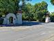 Long distance street view of neighborhood entrance flanked by decorative stone pillars and archways at 536 N Williams St, Denver, CO 80218