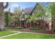 Lovely Tudor-style house featuring brickwork, lush greenery, and a well-maintained yard at 536 N Williams St, Denver, CO 80218