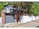 Exterior view of a home featuring Tudor architecture, a gray garage door and private gate at 536 N Williams St, Denver, CO 80218