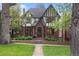 Charming Tudor-style home with brick facade, landscaped front yard, and inviting entrance at 536 N Williams St, Denver, CO 80218