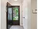 Unique foyer with black and white tile and a custom front door with a view to exterior at 536 N Williams St, Denver, CO 80218