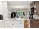 Bright kitchen boasts stainless steel appliances, island sink, breakfast nook, and an elegant chandelier at 536 N Williams St, Denver, CO 80218