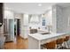 Bright kitchen featuring white cabinetry, marble backsplash, and stainless steel appliances at 536 N Williams St, Denver, CO 80218