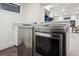 Modern laundry room featuring a sink and stainless steel, front loading washer and dryer at 536 N Williams St, Denver, CO 80218