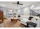 Bright living room features hardwood floors, a plush white sectional sofa and access to outdoor patio at 536 N Williams St, Denver, CO 80218