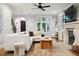 Living room area boasts black iron staircase, plush seating, tile floor, and bright view at 536 N Williams St, Denver, CO 80218