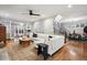 Spacious living room with hardwood floors, white sectional sofa, and staircase view at 536 N Williams St, Denver, CO 80218