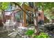 Back patio with a swing hanging from a mature tree and views of the brick exterior at 536 N Williams St, Denver, CO 80218