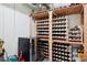 Basement wine cellar with custom built wooden shelving and built-in wine fridge at 536 N Williams St, Denver, CO 80218