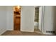 Bedroom with walk-in closet and attached bathroom featuring tile accents, offering convenience and privacy at 12512 E Cornell Ave # 101, Aurora, CO 80014