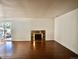 Spacious living room with hardwood floors and a decorative fireplace, providing a cozy focal point at 12512 E Cornell Ave # 101, Aurora, CO 80014