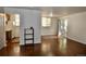Bright living room featuring hardwood floors and natural light, flowing into the adjacent kitchen at 12512 E Cornell Ave # 101, Aurora, CO 80014