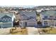 Aerial view of a gray two-story home surrounded by a residential neighborhood at 3323 Starry Night Loop, Castle Rock, CO 80109