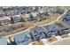 Overhead view displaying neighborhood homes, a walking path, and manicured lawns, set against clear skies at 3323 Starry Night Loop, Castle Rock, CO 80109