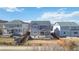 Aerial view of three homes, showcasing their well-kept lawns, fencing, and appealing curb appeal at 3323 Starry Night Loop, Castle Rock, CO 80109