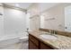 The bathroom boasts a granite countertop and a shower with bright white tile surround at 3323 Starry Night Loop, Castle Rock, CO 80109