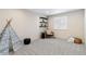 Cozy bedroom with neutral walls, gray carpet, accent chair, and built-in shelves at 3323 Starry Night Loop, Castle Rock, CO 80109