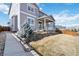 Charming two-story home with grey siding, white trim, and manicured landscaping with stone retaining wall at 3323 Starry Night Loop, Castle Rock, CO 80109