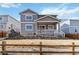 Beautiful two-story home with grey siding, white trim, and covered porch, complemented by professional landscaping at 3323 Starry Night Loop, Castle Rock, CO 80109