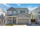 Charming gray two-story home featuring a covered porch and an attached two-car garage at 3323 Starry Night Loop, Castle Rock, CO 80109