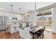 Modern eat-in kitchen with stainless appliances, granite counters, pendant lighting, and hardwood floors at 3323 Starry Night Loop, Castle Rock, CO 80109