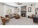 Cozy living room with a stone fireplace, comfortable seating, and natural light at 3323 Starry Night Loop, Castle Rock, CO 80109