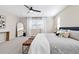 A lovely main bedroom features a stylish bed, bench, a ceiling fan, and large windows at 3323 Starry Night Loop, Castle Rock, CO 80109