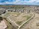 Aerial view of the neighborhood showcasing nearby parks, trails, and open green spaces at 22725 E Ottawa Pl, Aurora, CO 80016