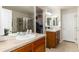 Bathroom features double sinks, neutral tile countertops, shower and walk-in closet at 22725 E Ottawa Pl, Aurora, CO 80016