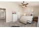 Bedroom with fan, bench, and soft neutral colors at 22725 E Ottawa Pl, Aurora, CO 80016