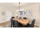 Chic dining area with a wooden table, grey chairs, and modern lighting and wall decor at 22725 E Ottawa Pl, Aurora, CO 80016