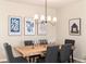 Elegant dining area featuring a wooden table, tufted chairs, stylish lighting, and tasteful wall art at 22725 E Ottawa Pl, Aurora, CO 80016