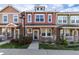 Charming two-story townhouse featuring a cozy front porch with stone accents and well-maintained landscaping at 22725 E Ottawa Pl, Aurora, CO 80016