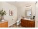 Cozy half bathroom features tile floors, a vanity with storage, and decorative accents at 22725 E Ottawa Pl, Aurora, CO 80016