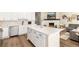 Kitchen with island that opens to the living room with a fireplace at 22725 E Ottawa Pl, Aurora, CO 80016