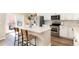 Modern kitchen with an island, stainless steel appliances, and a stylish backsplash at 22725 E Ottawa Pl, Aurora, CO 80016