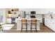 Modern kitchen featuring stainless steel appliances, white cabinetry, and a stylish island with seating at 22725 E Ottawa Pl, Aurora, CO 80016