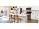 Bright kitchen with stainless steel appliances, white cabinets, and an island with seating at 22725 E Ottawa Pl, Aurora, CO 80016