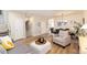Open concept living space with wood floors, modern furnishings, and a dining area at 22725 E Ottawa Pl, Aurora, CO 80016