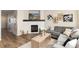 Bright living room features a fireplace, comfortable seating, and wood flooring at 22725 E Ottawa Pl, Aurora, CO 80016
