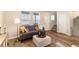 Well-lit living room with wood floors, a comfortable couch, stylish decor, and a staircase at 22725 E Ottawa Pl, Aurora, CO 80016