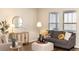 Cozy living room with wood floors, a comfortable couch, stylish decor, and plenty of natural light at 22725 E Ottawa Pl, Aurora, CO 80016