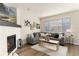 Comfortable living room with fireplace, large windows, and stylish decor create a relaxing atmosphere at 22725 E Ottawa Pl, Aurora, CO 80016