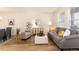 Bright living room featuring neutral decor, wood floors, a comfortable couch, and stylish furnishings at 22725 E Ottawa Pl, Aurora, CO 80016