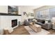 Cozy living room with fireplace, large windows, and a comfortable gray sofa at 22725 E Ottawa Pl, Aurora, CO 80016
